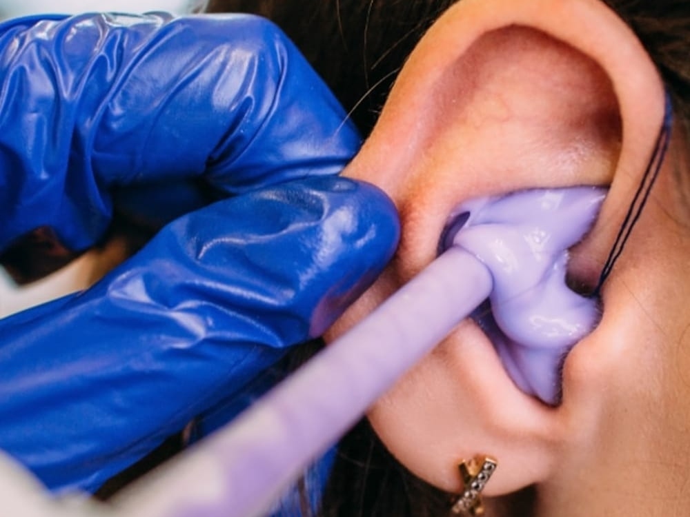 Doctor of Audiology taking a custom ear impression for hearing protection at Advanced Hearing Technology in Naples, FL