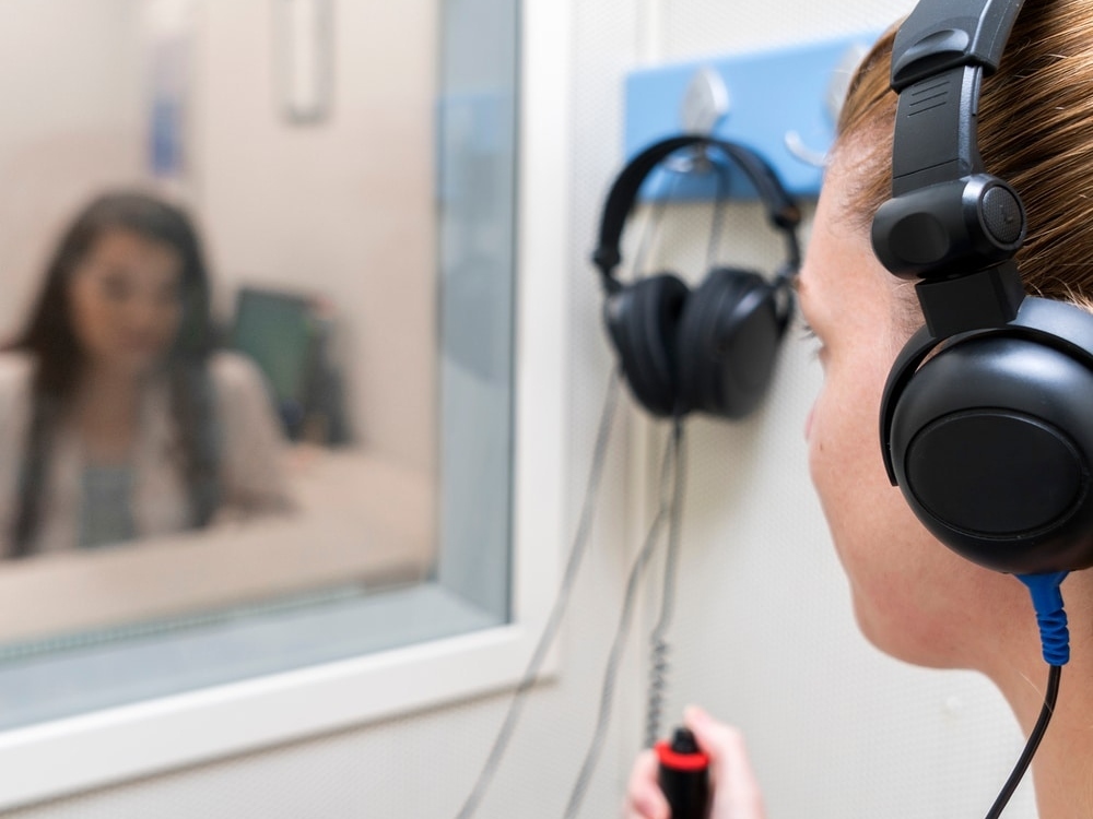 Doctor of Audiology conducting a hearing evaluation with a patient at Advanced Hearing Technology in Naples, FL